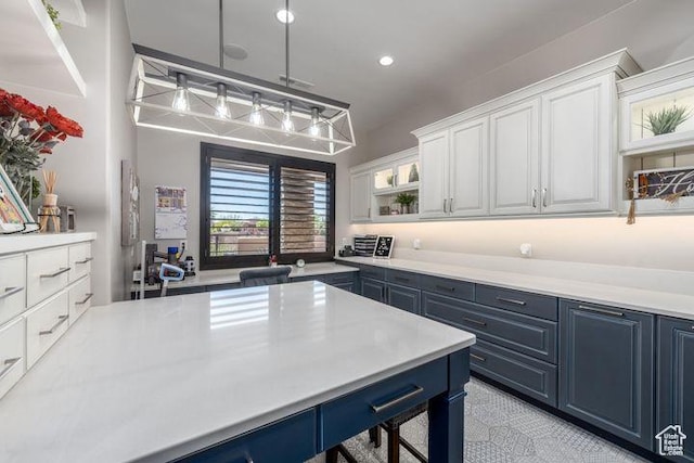 3052 N Snow Canyon Pkwy Unit 201, St George, UT 84770 - kitchen with light countertops, decorative light fixtures, and white cabinets