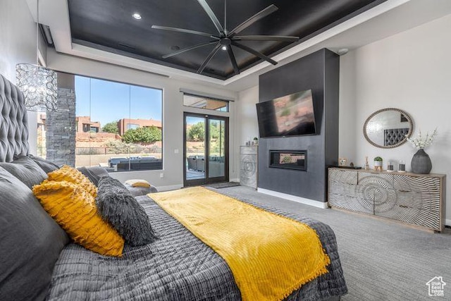 3052 N Snow Canyon Pkwy Unit 201, St George, UT 84770 - bedroom with carpet floors, a tray ceiling, a high ceiling, a glass covered fireplace, and access to outside