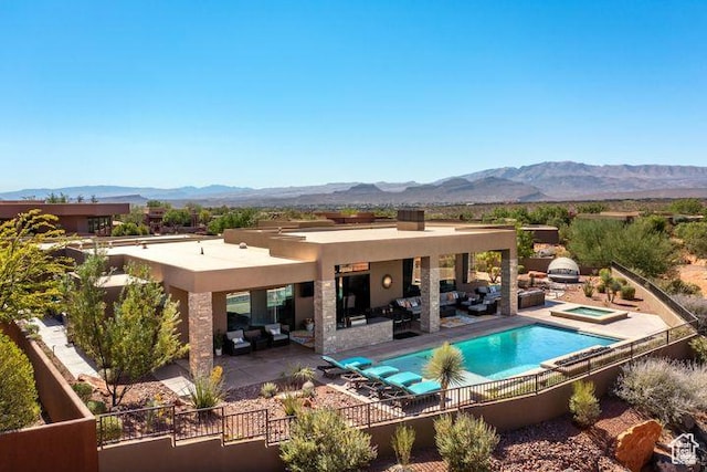 3052 N Snow Canyon Pkwy Unit 201, St George, UT 84770 - back of house featuring a patio area, fence, a mountain view, and an outdoor living space