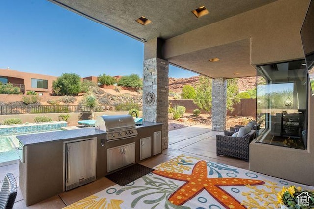 3052 N Snow Canyon Pkwy Unit 201, St George, UT 84770 - view of patio with exterior kitchen, a fenced backyard, and a grill
