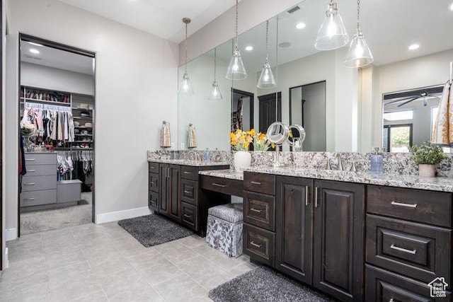 3052 N Snow Canyon Pkwy Unit 201, St George, UT 84770 - bathroom with baseboards, visible vents, a walk in closet, vanity, and recessed lighting