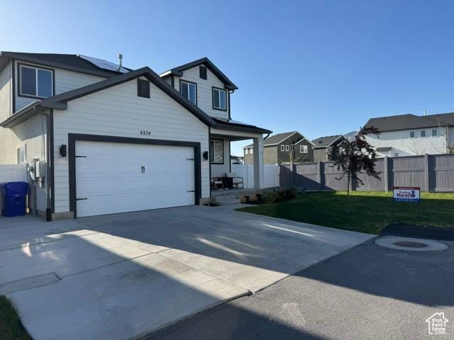 4834 E Hidden Steppe Bnd, Eagle Mountain, UT 84005 - view of front of house with a residential view, a front lawn, driveway, fence, and a garage