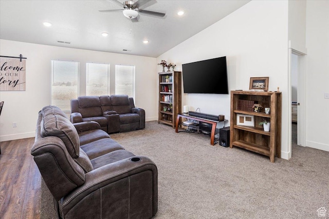 carpeted living area featuring visible vents, baseboards, a ceiling fan, and lofted ceiling