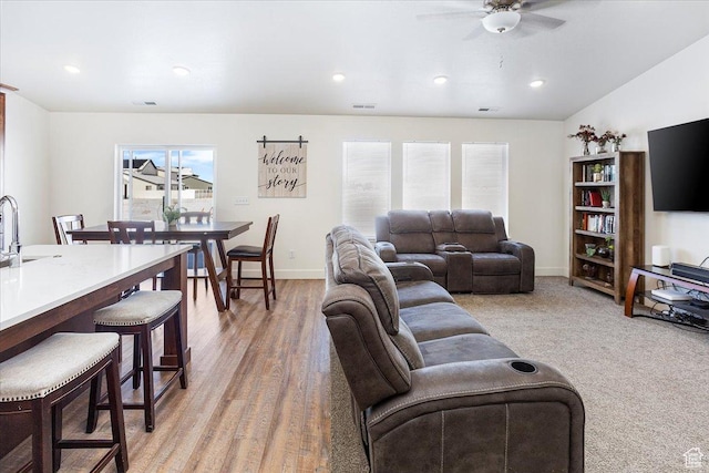 living area with ceiling fan, baseboards, visible vents, and recessed lighting