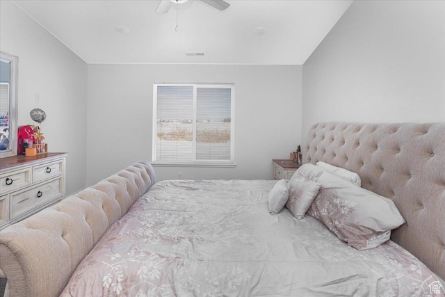 bedroom with visible vents, ceiling fan, and vaulted ceiling
