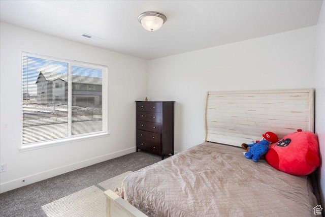 carpeted bedroom featuring baseboards and visible vents