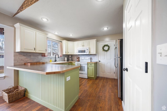 1320 W 1340 N, Pleasant Grove, UT 84062 - kitchen featuring a breakfast bar, white appliances, dark wood finished floors, and a peninsula