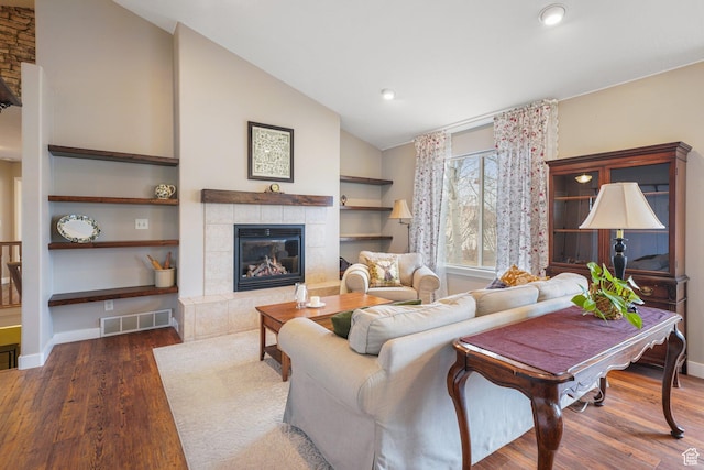 1320 W 1340 N, Pleasant Grove, UT 84062 - living room featuring baseboards, visible vents, a tile fireplace, lofted ceiling, and dark wood-type flooring