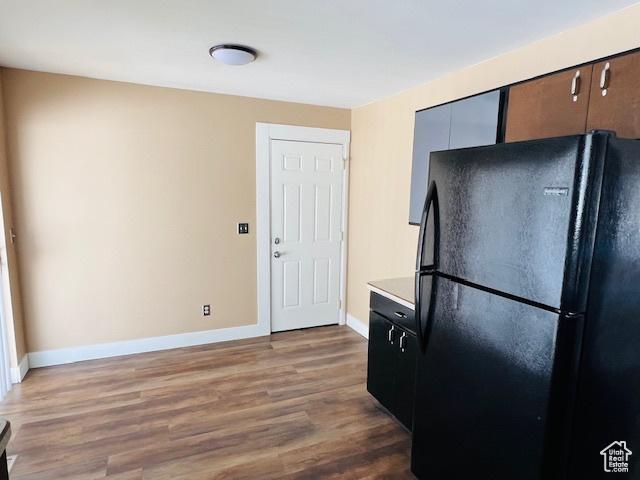 2299 W 5950 S, Roy, UT 84067 - kitchen with freestanding refrigerator, baseboards, wood finished floors, and light countertops