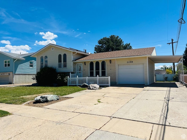 2299 W 5950 S, Roy, UT 84067 - split level home with driveway, a garage, brick siding, a carport, and a shingled roof