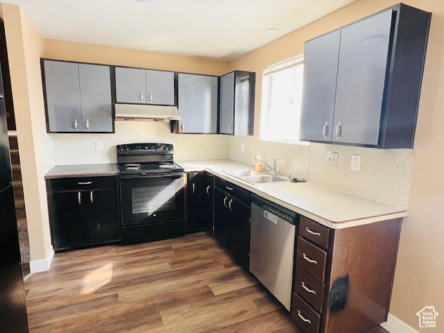 2299 W 5950 S, Roy, UT 84067 - kitchen featuring stainless steel dishwasher, black range with electric stovetop, under cabinet range hood, a sink, and wood finished floors