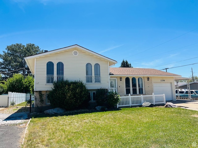 2299 W 5950 S, Roy, UT 84067 - tri-level home with brick siding, an attached garage, and driveway