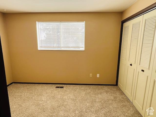 2299 W 5950 S, Roy, UT 84067 - unfurnished bedroom with a closet, light colored carpet, and baseboards