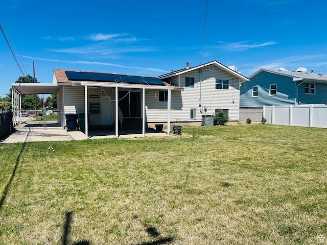 2299 W 5950 S, Roy, UT 84067 - rear view of house featuring roof mounted solar panels, a carport, and central AC