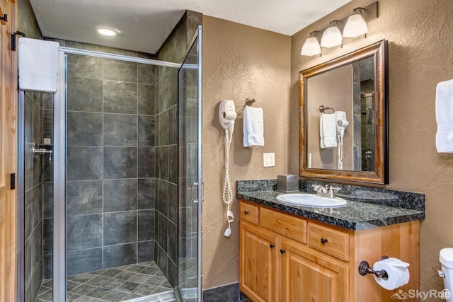 2653 W Canyons Resort Dr Unit 226, Park City, UT 84098 - full bath featuring a stall shower, a textured wall, vanity, and toilet