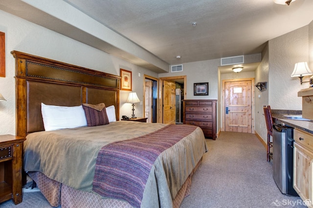 2653 W Canyons Resort Dr Unit 226, Park City, UT 84098 - bedroom with light colored carpet, visible vents, a textured wall, and a textured ceiling