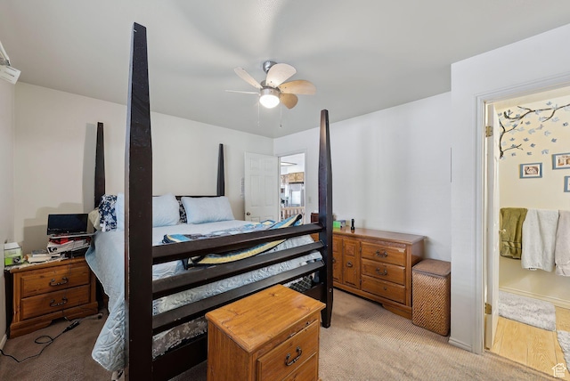 bedroom featuring light colored carpet and a ceiling fan