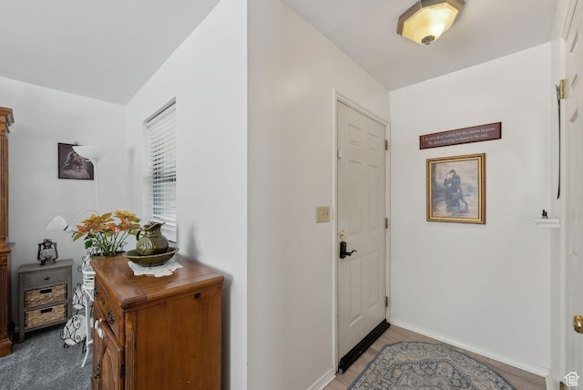 foyer entrance featuring baseboards
