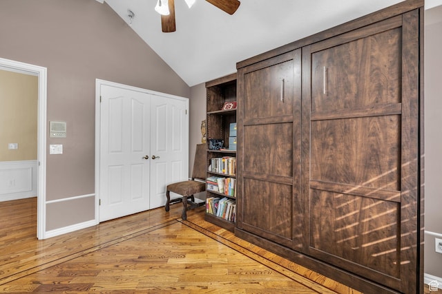 interior space featuring ceiling fan, lofted ceiling, and light wood finished floors