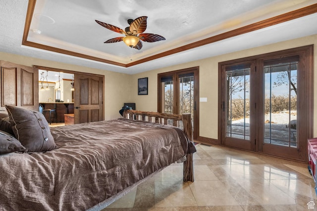 bedroom featuring a tray ceiling, access to exterior, baseboards, and french doors