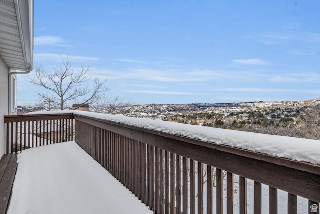 view of snow covered back of property