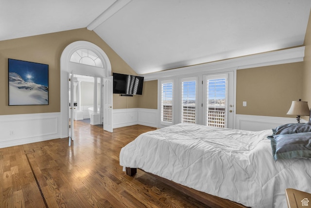 bedroom featuring wainscoting, lofted ceiling with beams, access to outside, and multiple windows