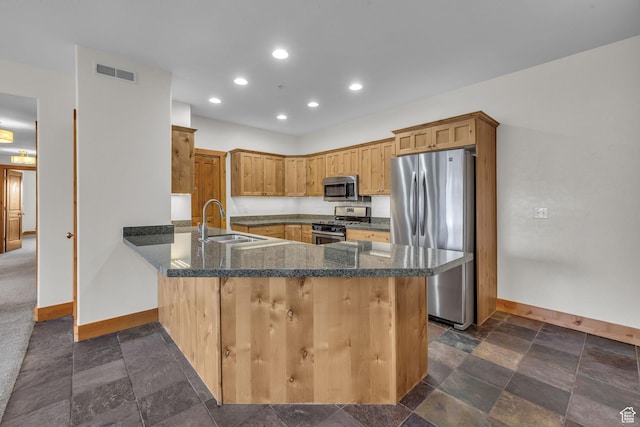4988 S Timber Way E Unit 310, Salt Lake City, UT 84117 - kitchen with baseboards, visible vents, a peninsula, stainless steel appliances, and a sink