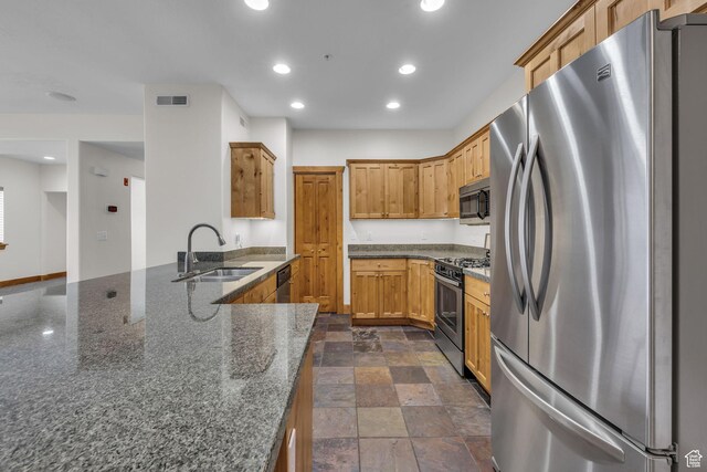 4988 S Timber Way E Unit 310, Salt Lake City, UT 84117 - kitchen with recessed lighting, a sink, appliances with stainless steel finishes, stone finish flooring, and dark stone countertops