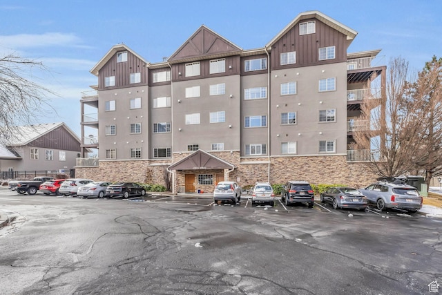 view of property featuring uncovered parking