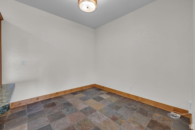 4988 S Timber Way E Unit 310, Salt Lake City, UT 84117 - empty room featuring stone finish flooring and baseboards