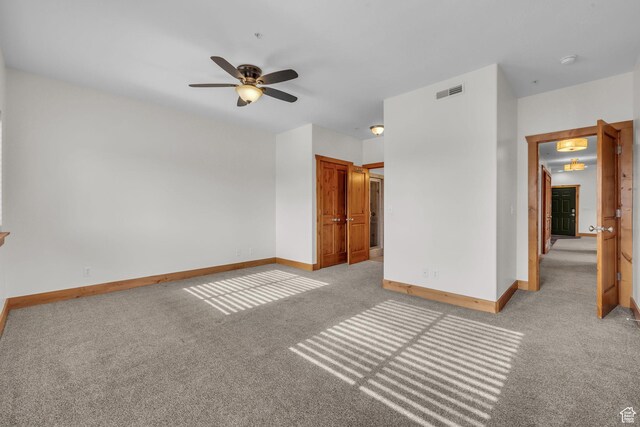 4988 S Timber Way E Unit 310, Salt Lake City, UT 84117 - unfurnished bedroom featuring a ceiling fan, light colored carpet, visible vents, and baseboards