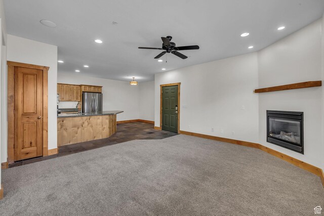 4988 S Timber Way E Unit 310, Salt Lake City, UT 84117 - unfurnished living room featuring baseboards, dark carpet, a glass covered fireplace, and recessed lighting