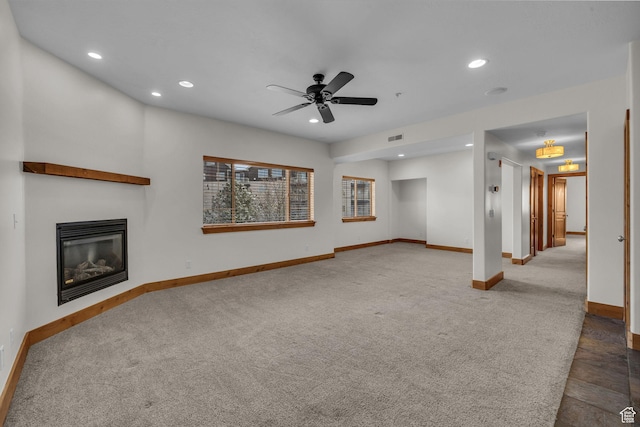 4988 S Timber Way E Unit 310, Salt Lake City, UT 84117 - unfurnished living room featuring a glass covered fireplace, visible vents, baseboards, and recessed lighting