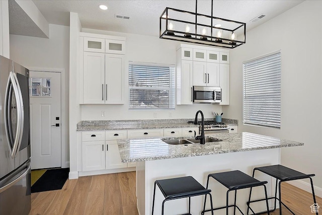 3543 N Creekside Way E Unit 63, Eden, UT 84310 - kitchen with appliances with stainless steel finishes, white cabinetry, and glass insert cabinets