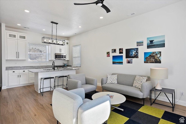 3543 N Creekside Way E Unit 63, Eden, UT 84310 - living area with a textured ceiling, light wood-style flooring, visible vents, and baseboards