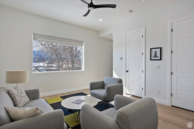 3543 N Creekside Way E Unit 63, Eden, UT 84310 - living area featuring light wood-style floors, a textured ceiling, baseboards, and a ceiling fan