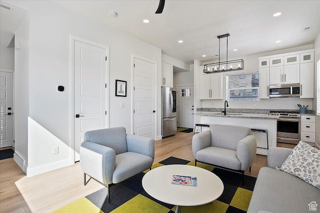 3543 N Creekside Way E Unit 63, Eden, UT 84310 - living area with recessed lighting, visible vents, light wood-style floors, a textured ceiling, and baseboards