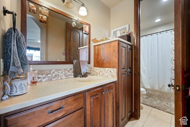 bathroom featuring toilet, tile patterned flooring, and vanity