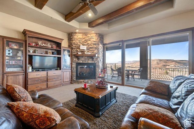 living room featuring a wealth of natural light, a mountain view, and beamed ceiling