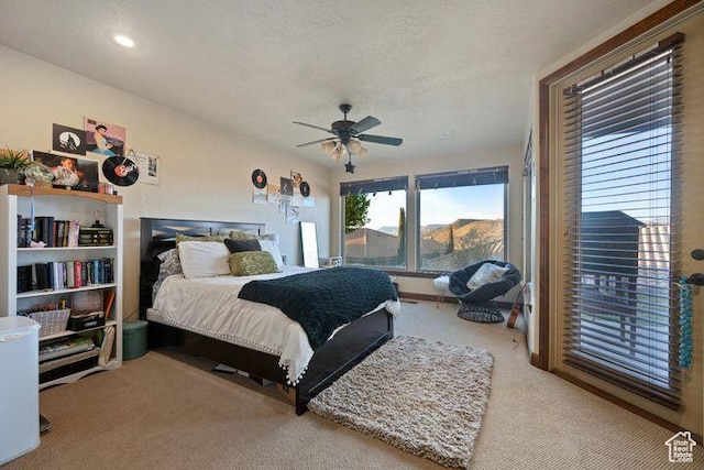 bedroom featuring light carpet, a textured ceiling, a ceiling fan, and recessed lighting