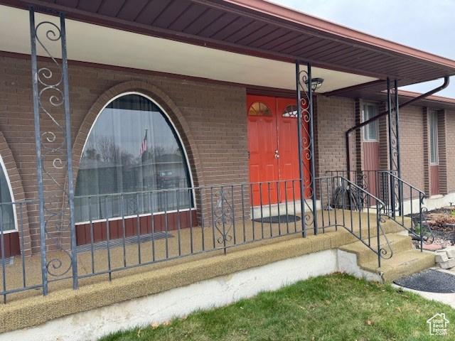 entrance to property with brick siding