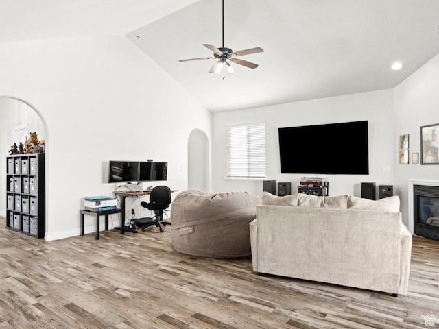 4863 N Shady Hollow Ln W, Lehi, UT 84043 - living room featuring baseboards, arched walkways, ceiling fan, wood finished floors, and high vaulted ceiling