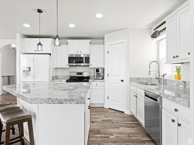 4863 N Shady Hollow Ln W, Lehi, UT 84043 - kitchen with a sink, white cabinets, wood finished floors, and stainless steel appliances