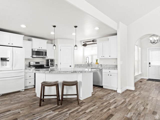 4863 N Shady Hollow Ln W, Lehi, UT 84043 - kitchen with appliances with stainless steel finishes, dark wood-style flooring, white cabinets, and a kitchen island