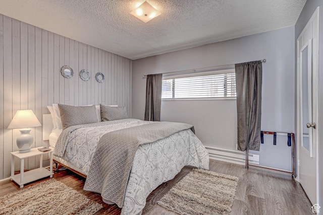 356 S S Hwy Unit A-1, Brian Head, UT 84719 - bedroom with a baseboard radiator, a textured ceiling, and wood finished floors
