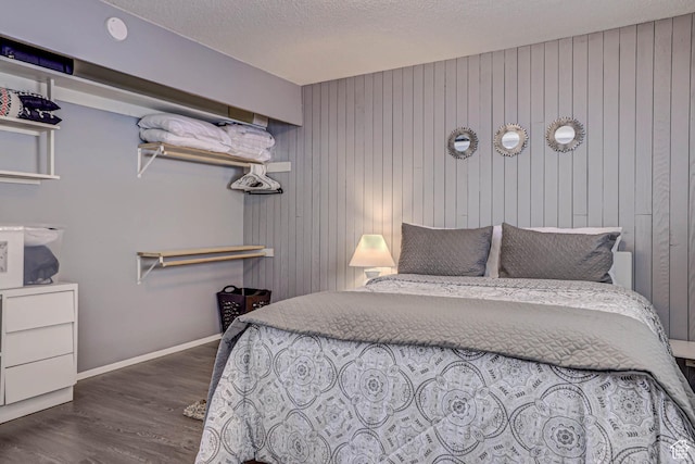 356 S S Hwy Unit A-1, Brian Head, UT 84719 - bedroom with wood walls, baseboards, dark wood finished floors, and a textured ceiling