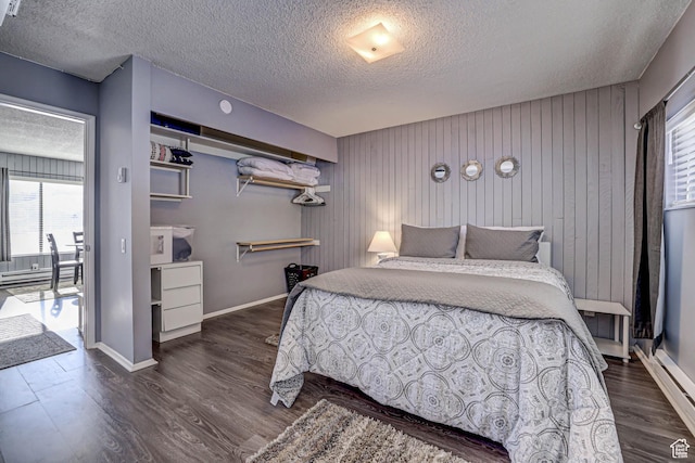 356 S S Hwy Unit A-1, Brian Head, UT 84719 - bedroom with dark wood-style floors, baseboards, a textured ceiling, and wood walls
