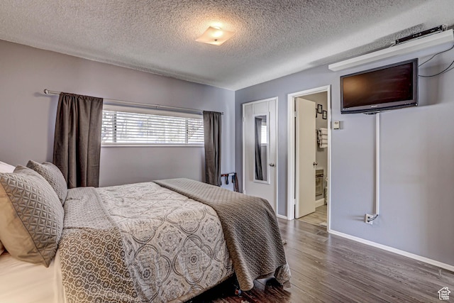 356 S S Hwy Unit A-1, Brian Head, UT 84719 - bedroom featuring a textured ceiling, wood finished floors, connected bathroom, and baseboards