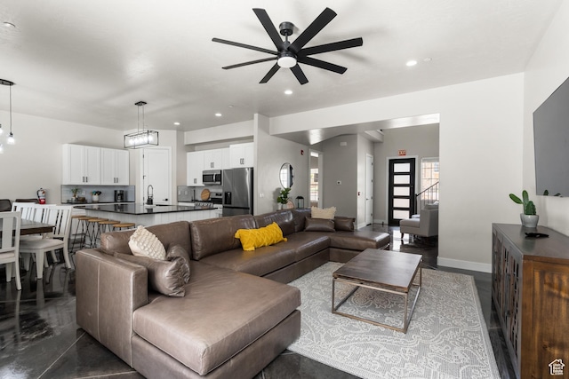 living room with recessed lighting, ceiling fan, and baseboards