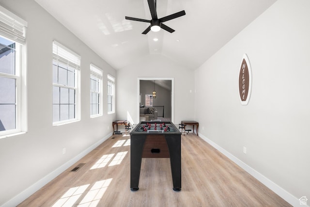 playroom featuring baseboards, visible vents, vaulted ceiling, and light wood finished floors